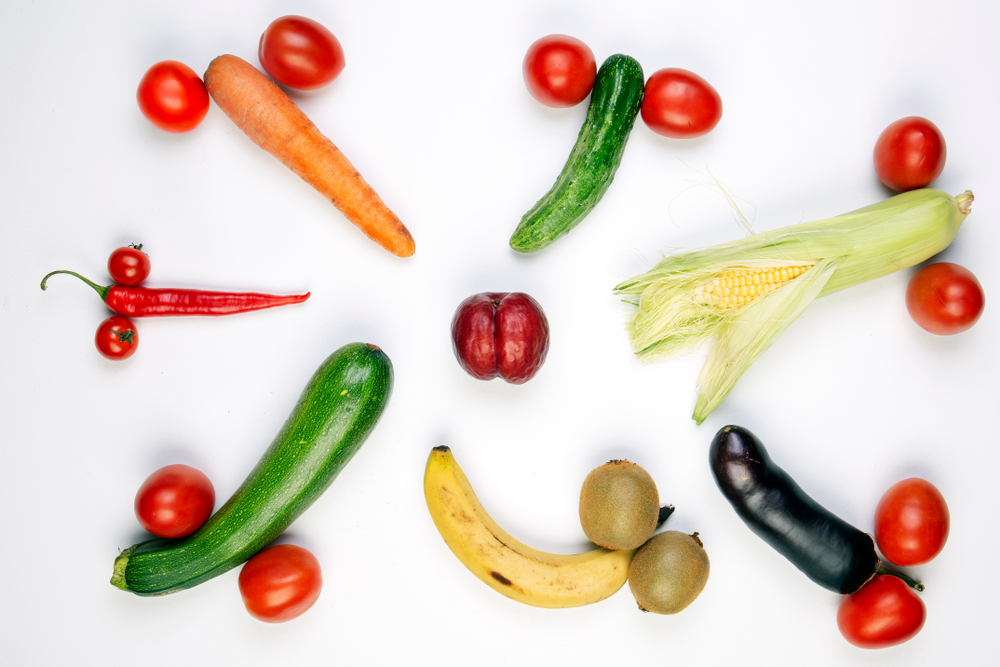 One fruit meant to symbolize a vagina surrounded by other arrangements of fruit and vegetables meant to resemble penises and testicles.